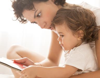 baby and mother with book