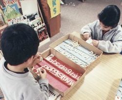 Children using clay to mold alphabet