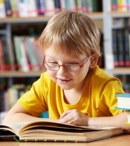 small boy reading book